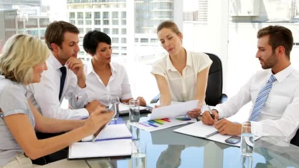 Business people going over figures at meeting — Stock Video