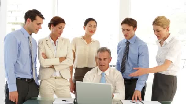 Business team talking in front of laptop then pointing to camera — Stock Video