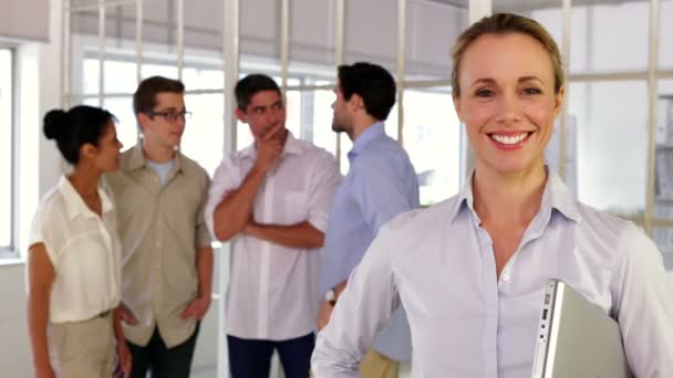 Content blonde businesswoman posing in front of her colleagues — Stock Video