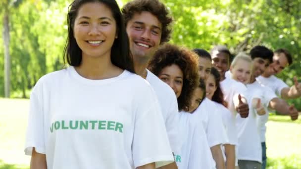 Volunteers standing in a row giving thumbs up to camera — Stock Video