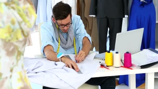 Designer measuring sheet of fabric — Stock Video
