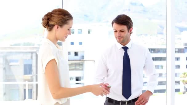 Businessman giving card to businesswoman — Stock Video