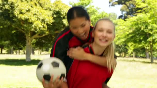 Female football teammates celebrating a win in the park — Stock Video