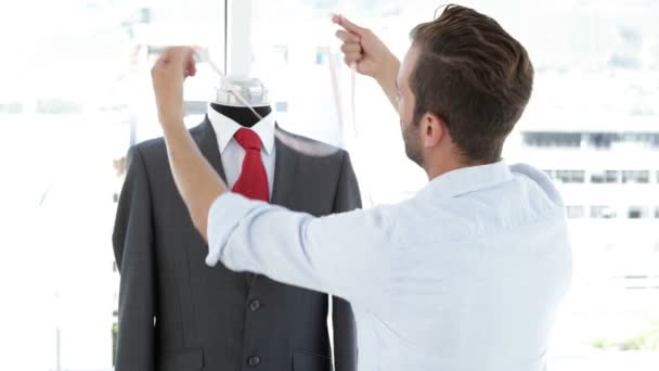 Handsome tailor measuring suit on mannequin — Stock Video