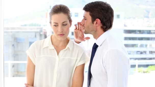 Businessman whispering a secret to his colleague — Stock Video