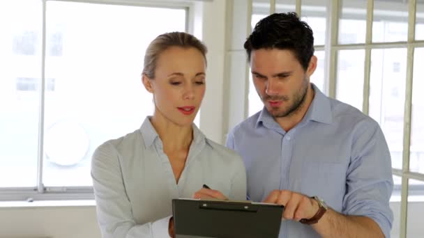 Young attractive colleagues working together on a tablet — Stock Video