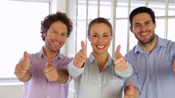 Gleeful colleagues showing thumbs up to camera — Stock Video