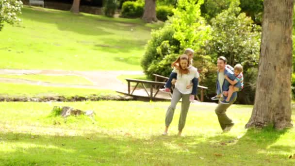 Happy family playing chasing in the park together Stock Footage