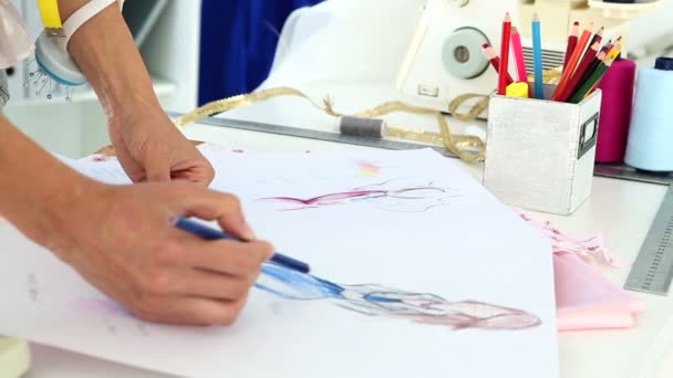 Fashion designer sketching a blue dress design — Stock Video