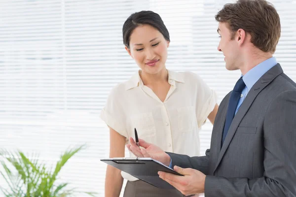 Business colleagues with clipboard at office — Stock Photo, Image