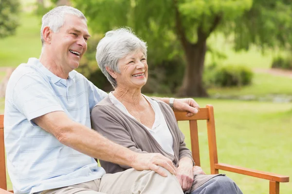 Side view of senior couple sitting on bench at park — Stock Photo, Image