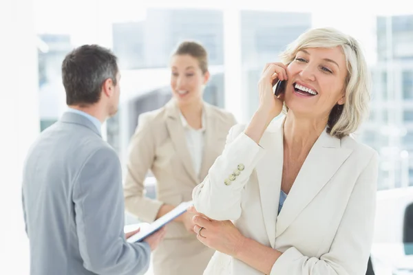 Businesswoman on call with colleagues discussing at office — Stock Photo, Image
