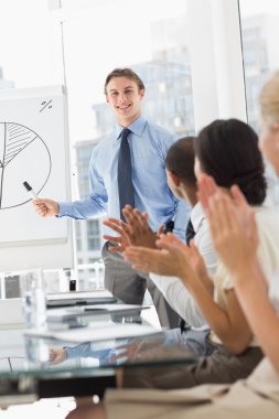 Businessman being applauded for his presentation clipart