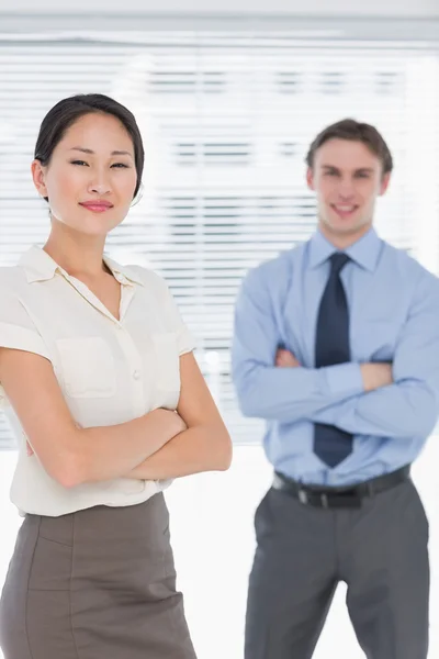 Business colleagues with arms crossed in office — Stock Photo, Image