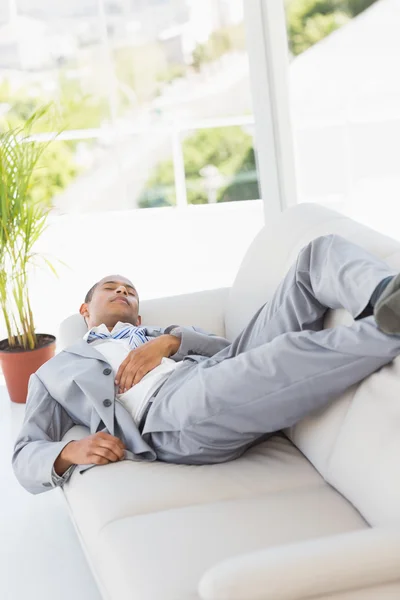 Businessman sleeping on the couch — Stock Photo, Image