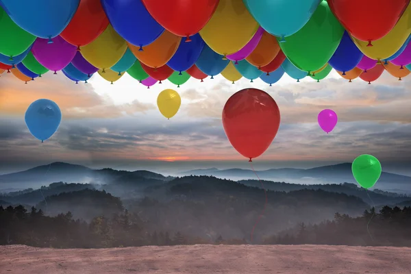 Många färgglada ballonger över landskapet — Stockfoto