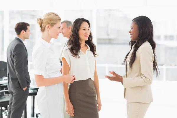 Businesswomen speaking together in conference room — Stock Photo, Image