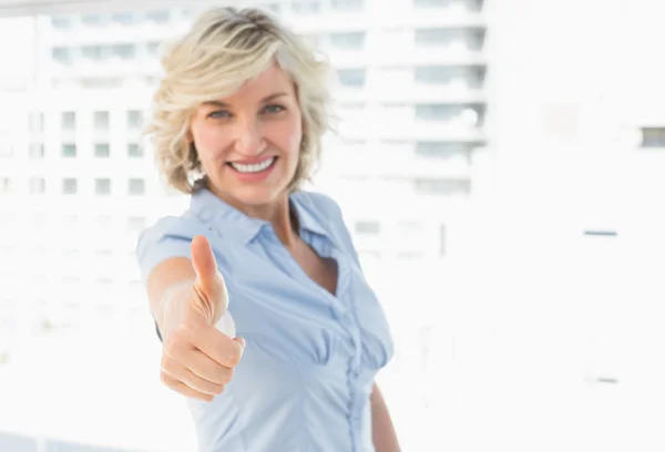 Elegant businesswoman gesturing thumbs up — Stock Photo, Image