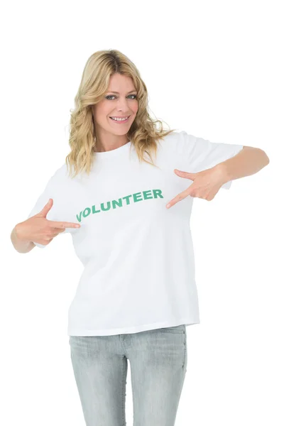 Portrait of a happy female volunteer pointing to herself — Stock Photo, Image