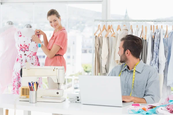 Hombre usando portátil con diseñador de moda trabajando en el estudio —  Fotos de Stock