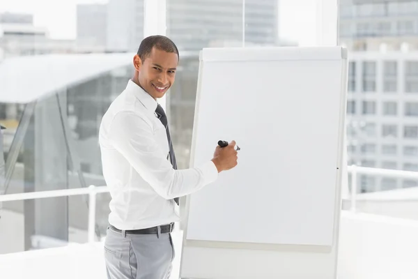 Jovem empresário feliz apresentando no quadro branco com marcador — Fotografia de Stock