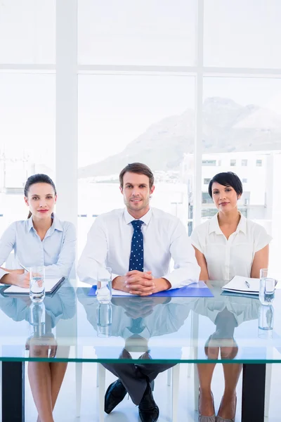 Smartly dressed young executives sitting at desk — Stock Photo, Image