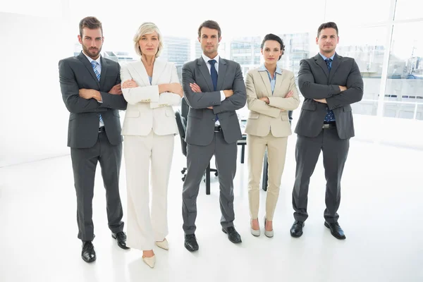 Confident business team with arms crossed in office — Stock Photo, Image