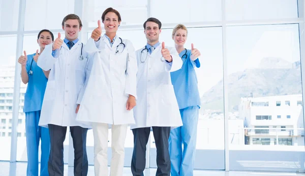 Doctors gesturing thumbs up at hospital — Stock Photo, Image