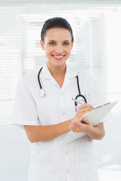 Portrait of a beautiful female doctor with clipboard — Stock Photo, Image