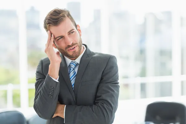 Giovane uomo d'affari con forte mal di testa in ufficio — Foto Stock