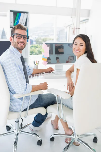 Rear view of casual photo editors working on computer — Stock Photo, Image