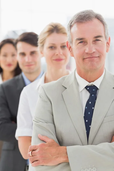 Geschäftsteam steht in einer Schlange und lächelt in die Kamera — Stockfoto