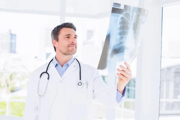 Serious male doctor examining x-ray — Stock Photo, Image