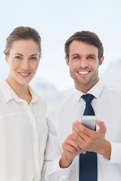 Smartly dressed colleagues with a mobile phone — Stock Photo, Image