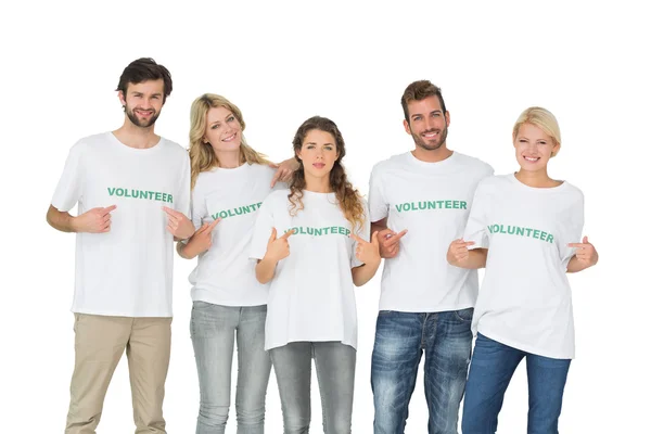 Group portrait of happy volunteers pointing to themselves — Stock Photo, Image