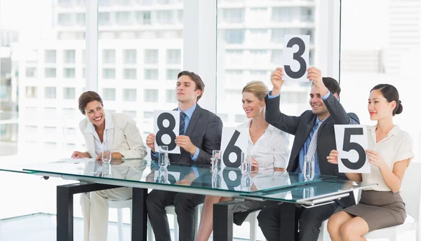 Judges in a row holding score signs — Stock Photo, Image