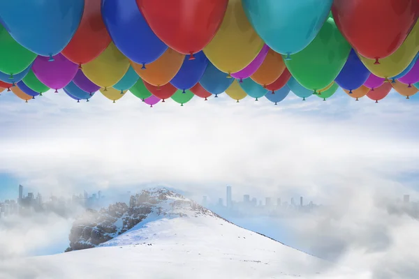 Many colourful balloons above snow — Stock Photo, Image