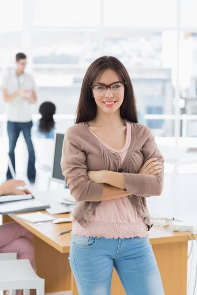 Female artist with colleagues in the background at office — Stock Photo, Image