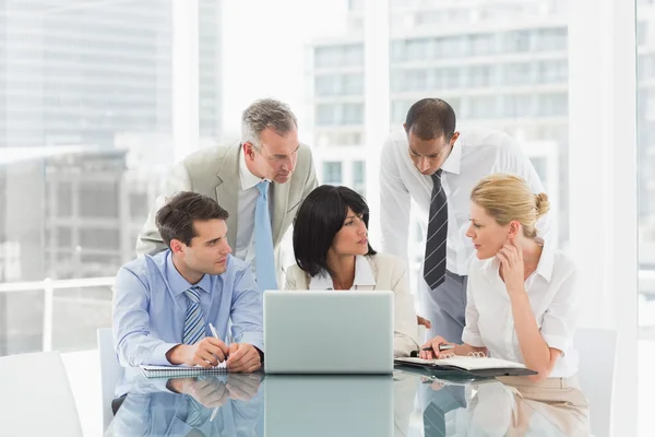 Business people gathered around laptop discussing — Stock Photo, Image