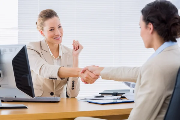 Netjes geklede vrouwen schudden handen in zakelijke bijeenkomst — Stockfoto