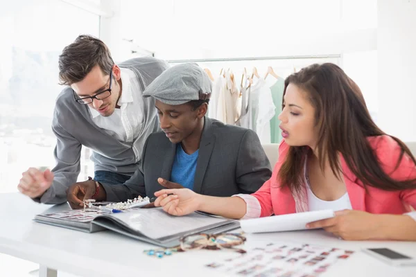 Fashion designers discussing designs — Stock Photo, Image