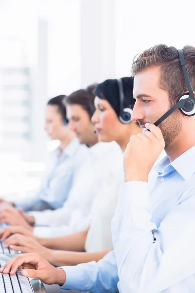 Compañeros de negocios con auriculares en fila — Foto de Stock