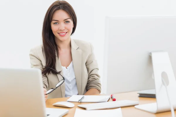 Young woman with computers at desk in office — Stock Photo, Image