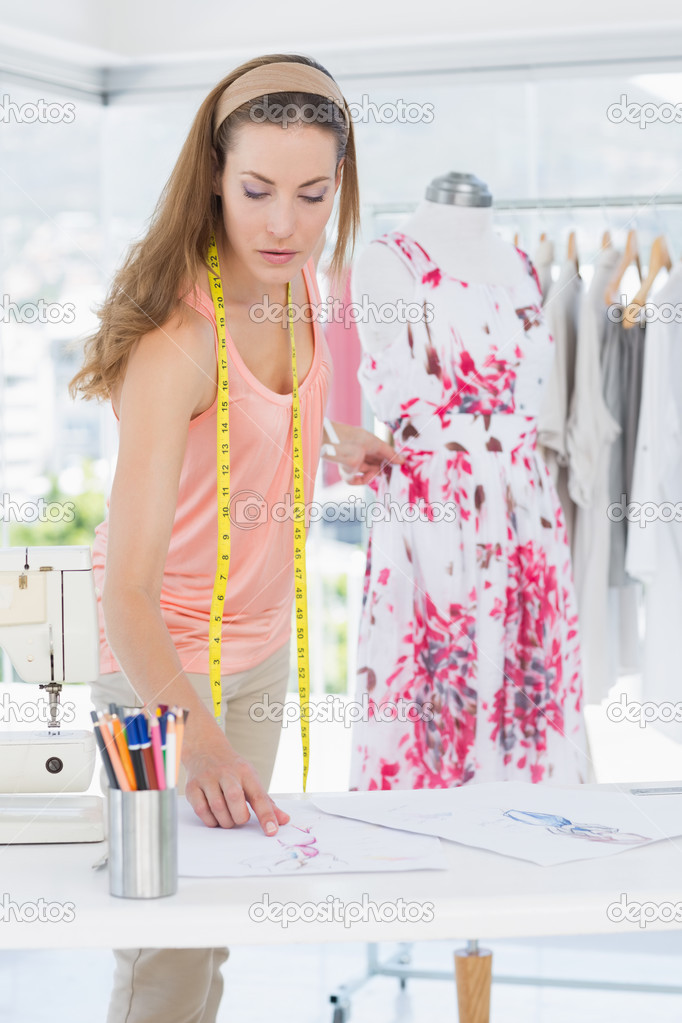 Female fashion designer working on floral dress — Stock Photo ...