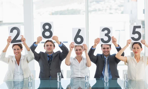 Group of panel judges holding score signs — Stock Photo, Image