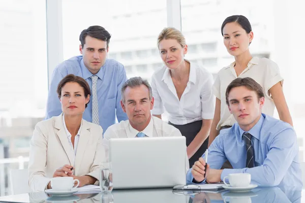 Business colleagues with laptop at desk — Stock Photo, Image