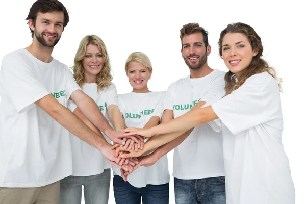 Group portrait of happy volunteers with hands together — Stock Photo, Image