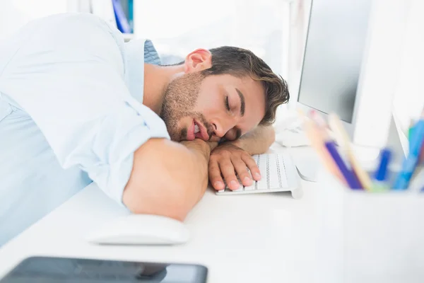 Male artist with head resting on keyboard — Stock Photo, Image