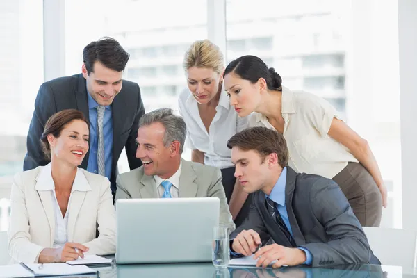 Business colleagues with laptop at desk — Stock Photo, Image