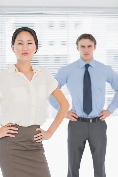 Business colleagues with hands on hips in office — Stock Photo, Image